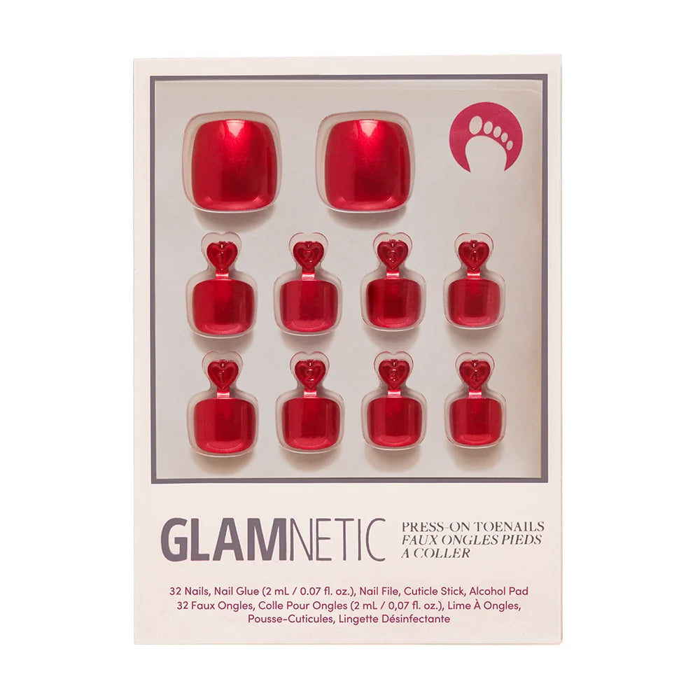 A box of Glamnetic press-on toenails in a deep ruby red with a metallic sheen.