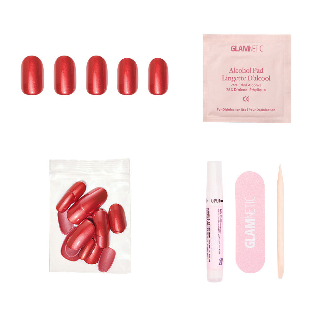 The glamnetic Cherry Glaze set includes short round press-on nails in vibrant cherry-red, plus an alcohol pad, extra nails, nail glue, a pink nail file, and a wooden cuticle stick—all displayed on a white background.