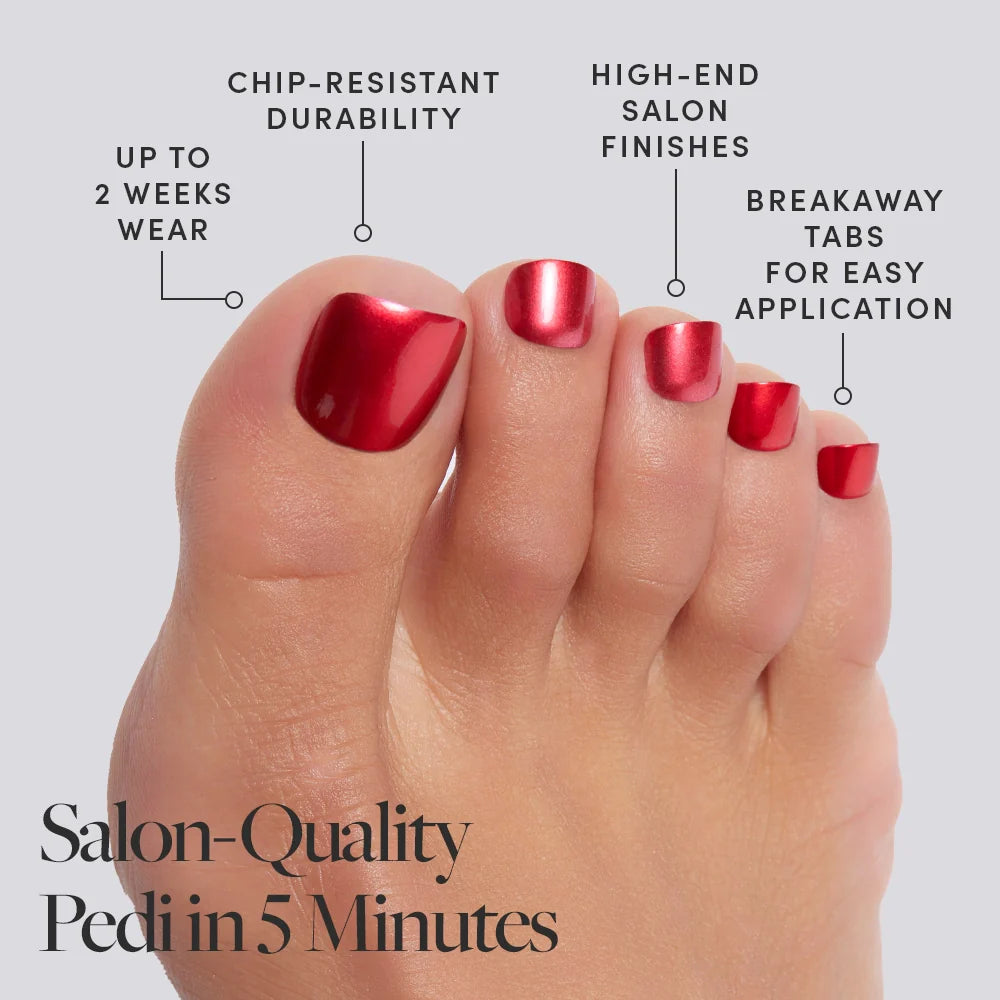 A foot wearing shiny, bold red color Glamnetic press-on toenails with product features called out, including salon finish and 2-week wear.