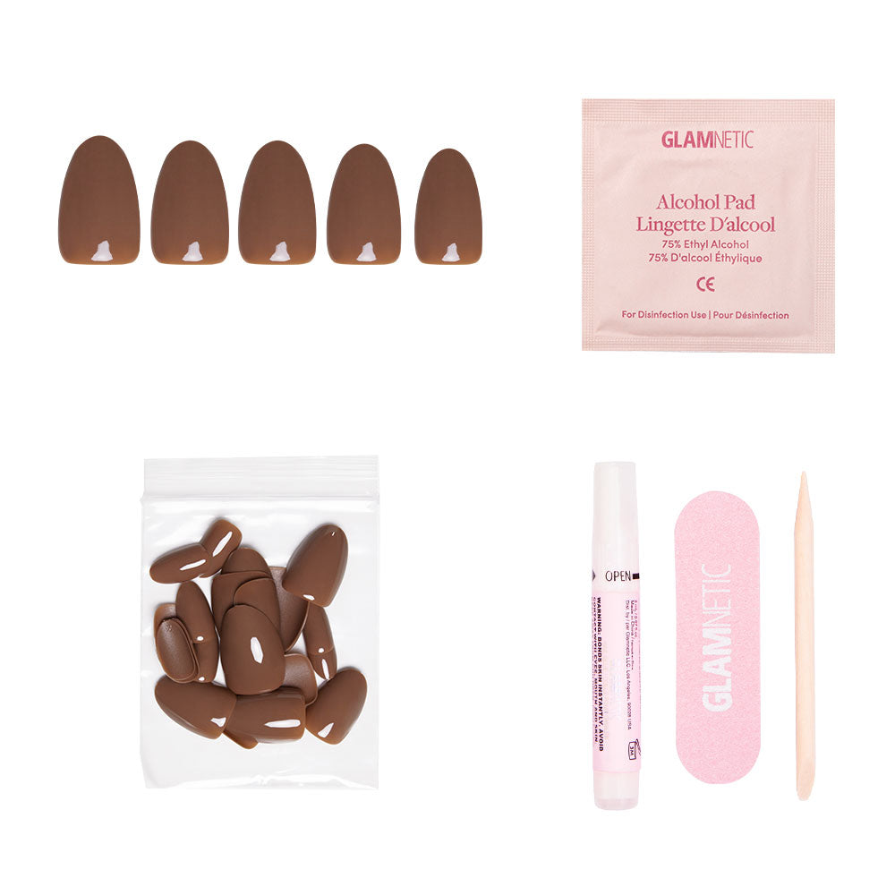 The glamnetic Chocolate Brown Nail Set includes press-on nails, an alcohol pad, extra nails, nail glue, a pink file, and a wooden cuticle stick—perfect for cozy Fall Forest-inspired manicures on a white background.