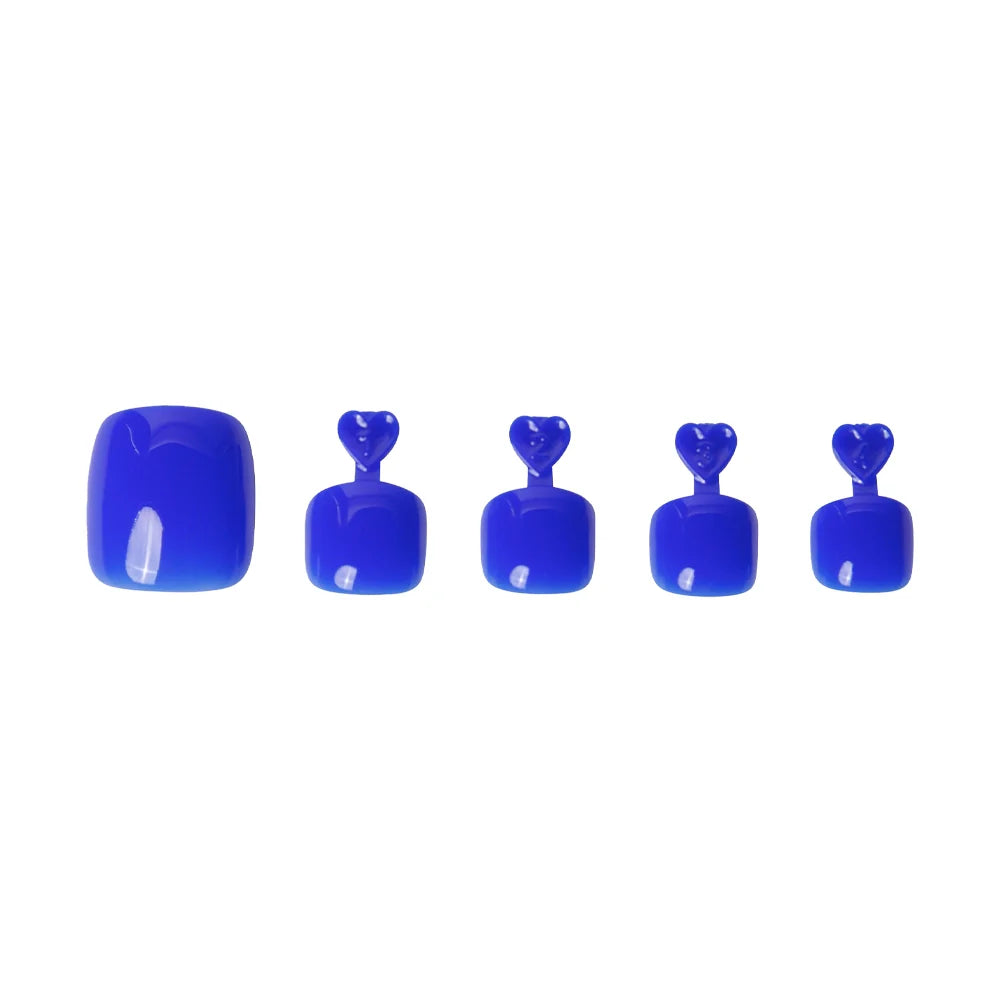 Glossy cobalt blue press-on toenails in five sizes, each with heart-shaped tabs for application.