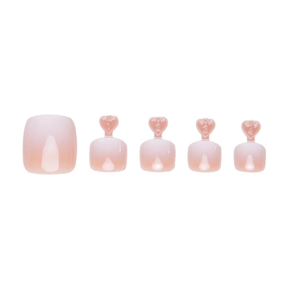 Peachy  nude ombre press-on toenails in five sizes, each with heart-shaped tabs for application.