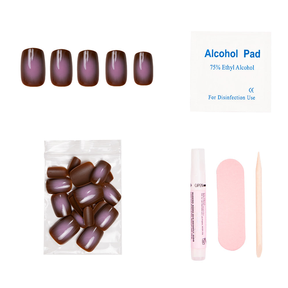 The glamnetic Eclipse Nail Set showcases a brown and purple ombre in an earthy taupe hue, and includes an alcohol pad, nail glue tube, pink nail file, wooden cuticle stick, and extra nails.
