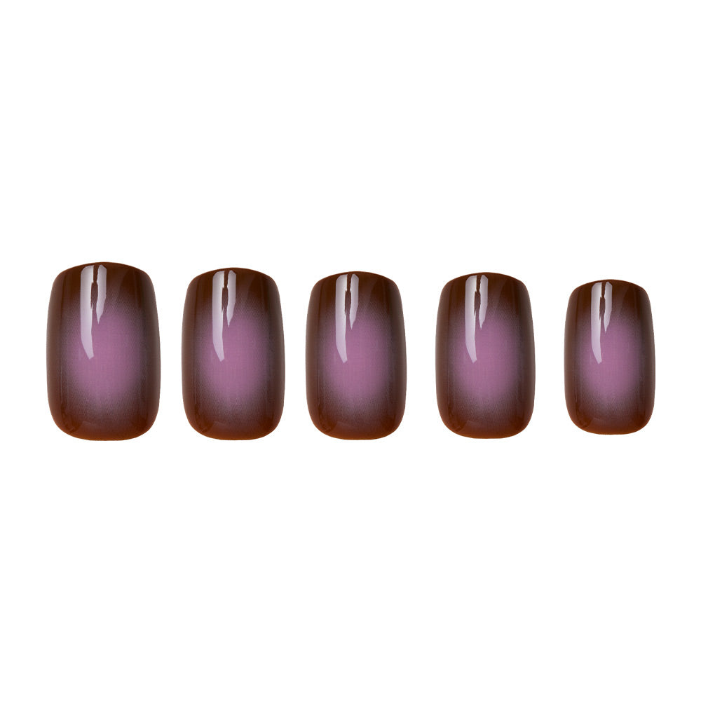 Five artificial nails from the glamnetic Eclipse set are displayed on a white background, each in a short squoval shape with a glossy gradient fading from earthy taupe brown at the edges to soft pinkish-purple at the center.