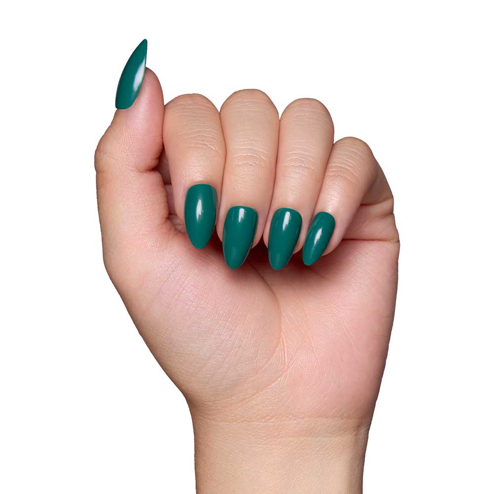 A hand with long, almond-shaped nails painted in glamnetic’s Emerald Green, a glossy polish, shown against a white background.