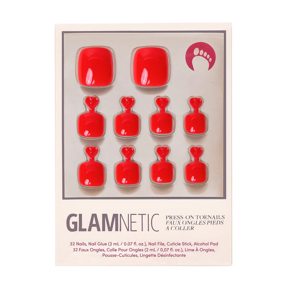 A box of Glamnetic press-on toenails in a bold, glossy red shade.