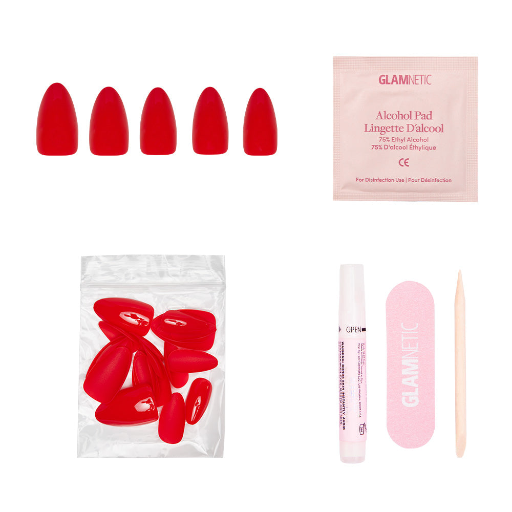 The glamnetic Fiery Red press-on nail set includes nails, an alcohol pad, extra nails, nail glue, a pink file, and a cuticle stick—everything you need for bold summer nails.