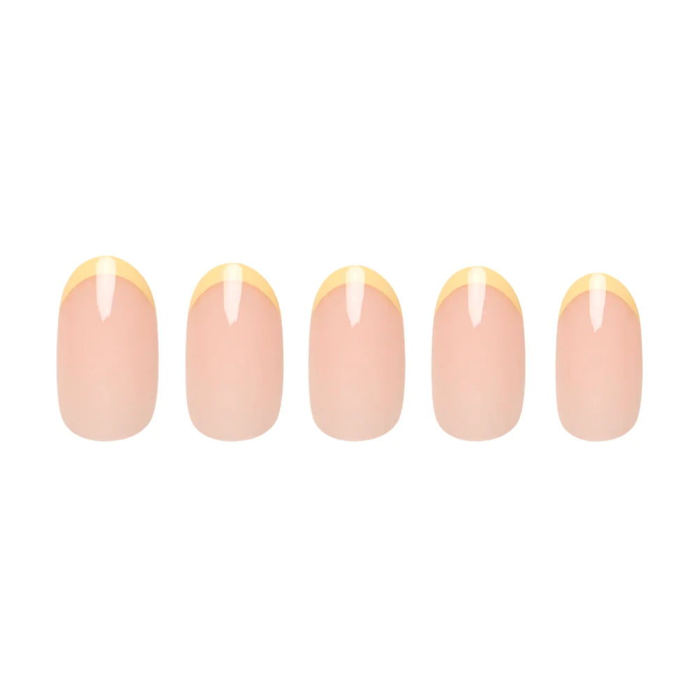 Five artificial nails from glamnetic’s French Butter set, featuring nude bases and pastel yellow French tips, are arranged in a row on a white background to highlight their elegance and salon-quality durability.