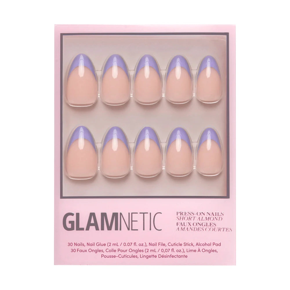 The glamnetic French Lilac set features 30 short almond press-on nails with a nude base and pastel purple tips, plus nail care accessories, all in a sleek pink package.