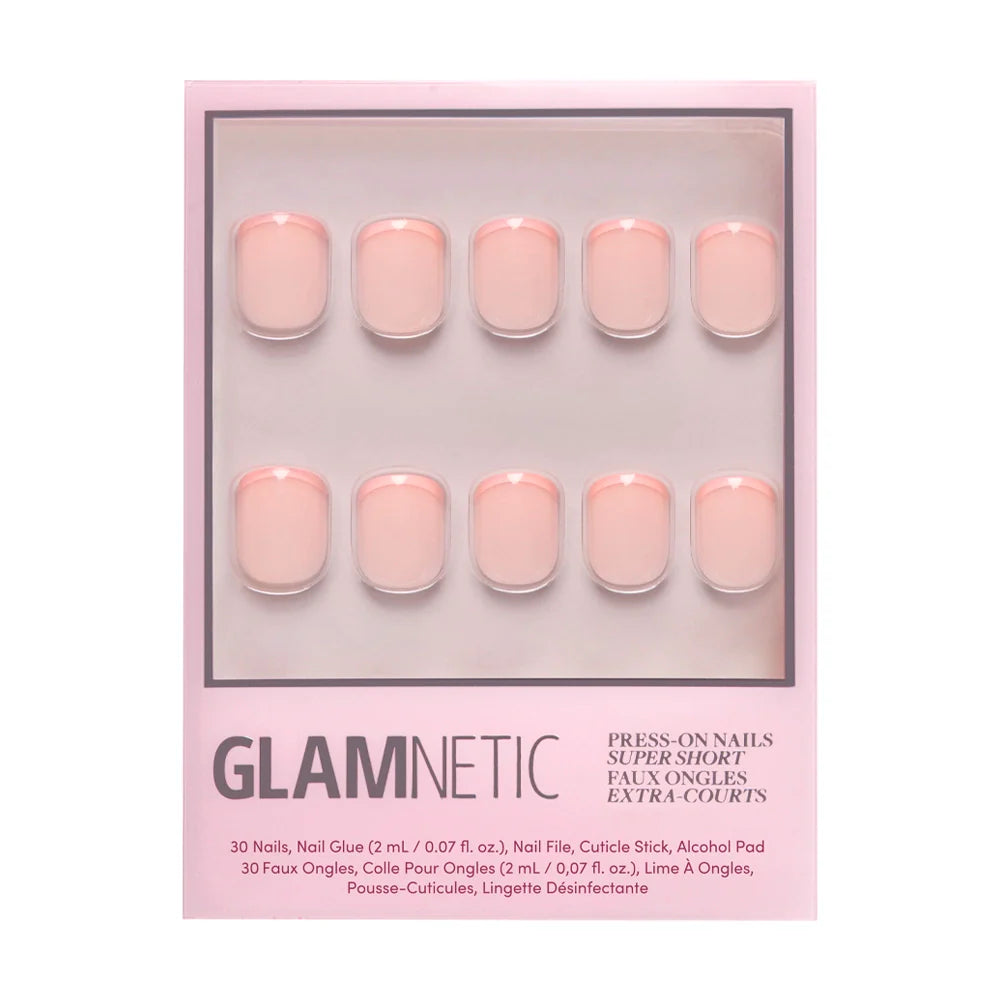 A box of glamnetic French Peach Press-On Nails in pale pink includes 10 super short, rounded nails arranged in two rows on a pink background. Vegan and cruelty-free.