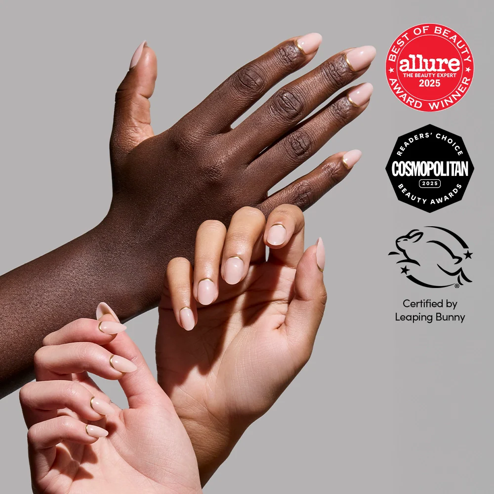Four hands with manicured, nude-colored, short oval nails wearing glamnetic's Glam Goals are shown against a neutral background. Beauty award badges from Allure and Cosmopolitan, plus Leaping Bunny certification, appear on the right.