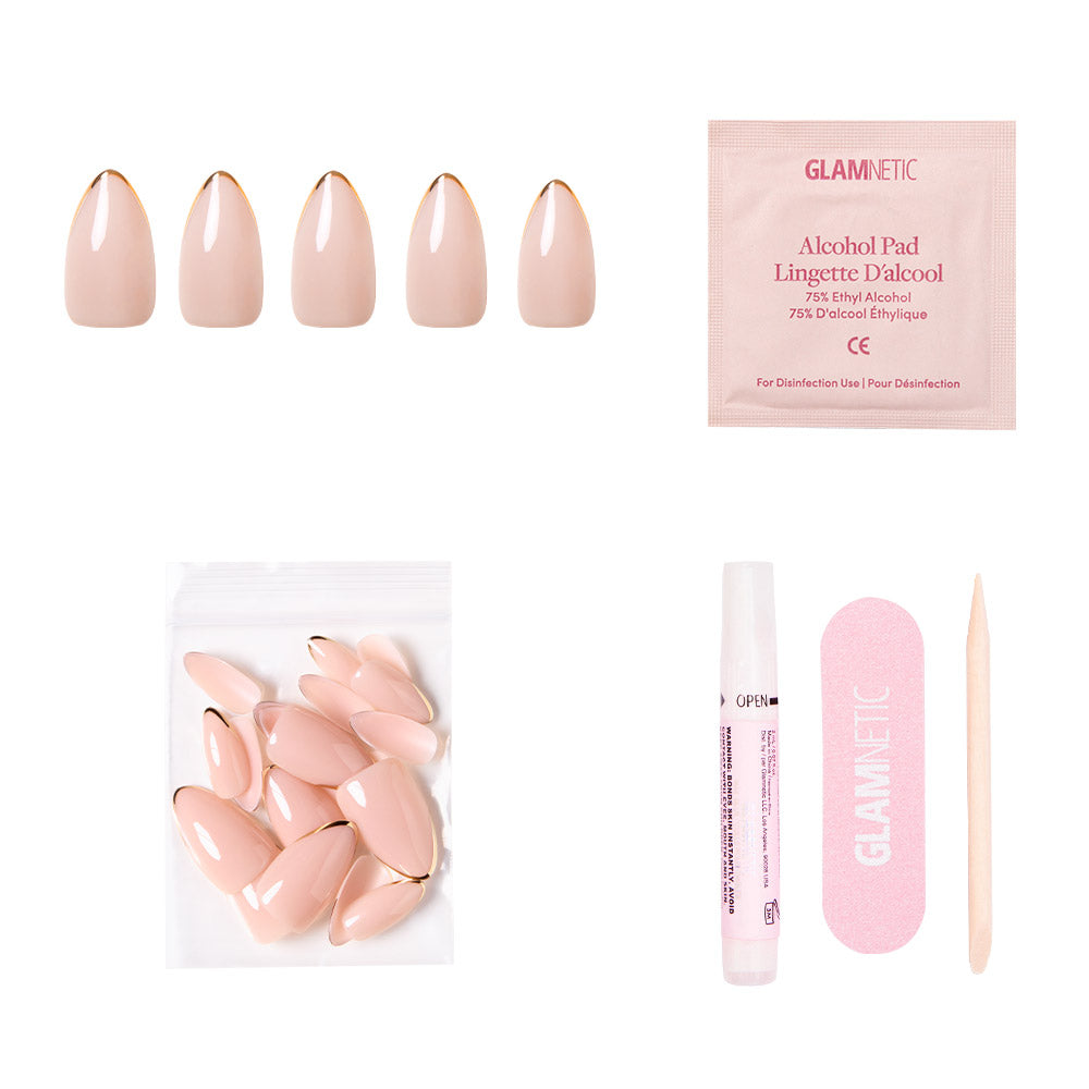 Gold Standard by glamnetic: almond nude nails with metallic gold tips. Includes alcohol pad, extra nails, nail glue, pink file, and wooden cuticle stick—all displayed on a white background.