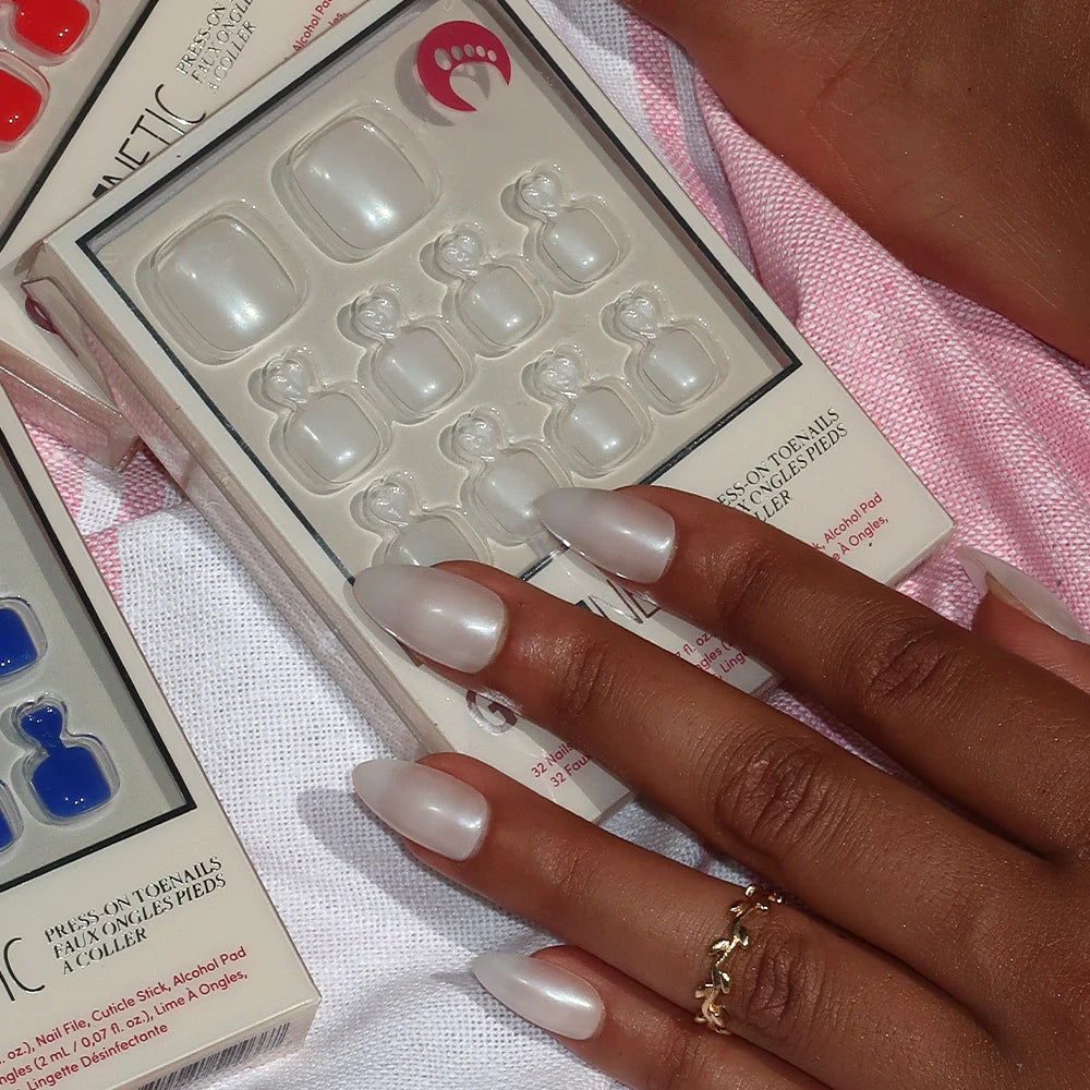 Nail art kit with press-on nails and a hand with press-on nails.