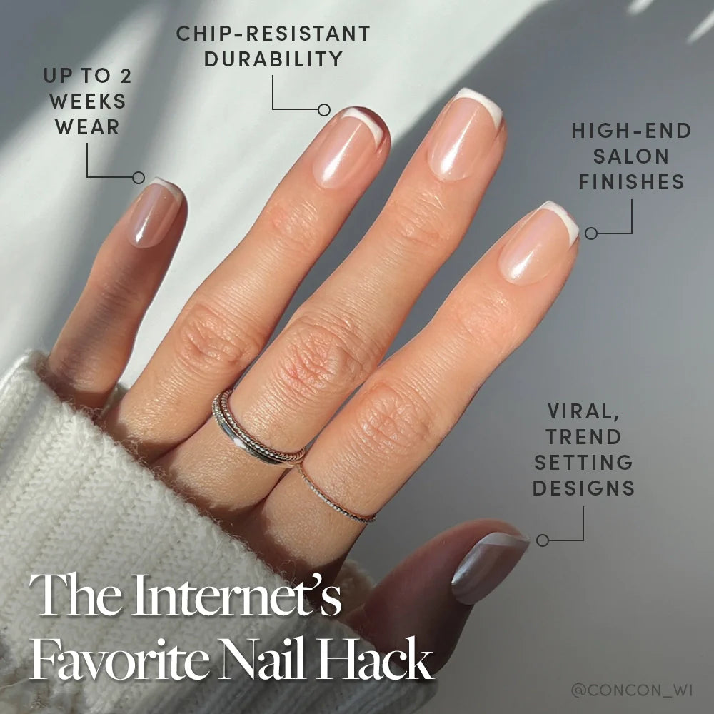 A hand with short squoval French tip nails from glamnetic’s La Perle set is shown in natural light with delicate rings. The text highlights up to two weeks’ chip-resistant wear and trendy designs.