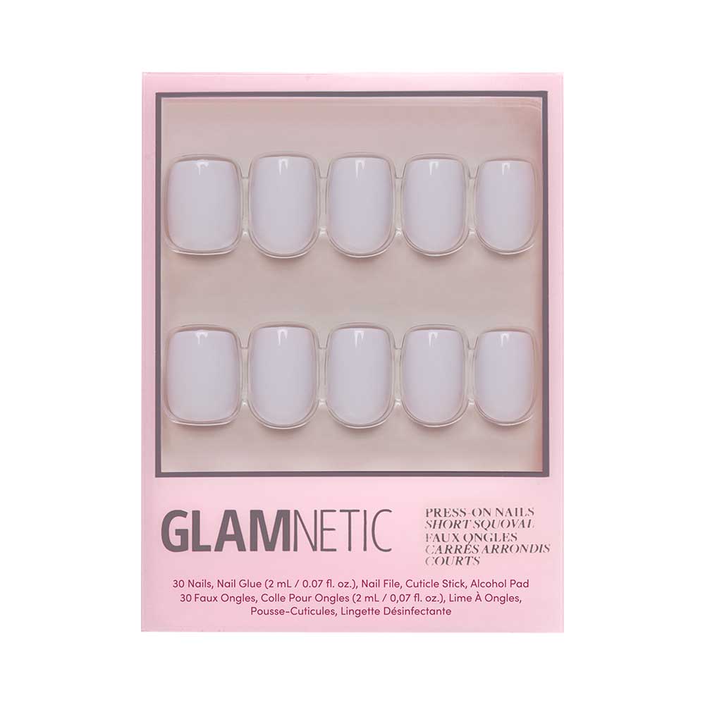 A package of glamnetic Lilac Gray press-on nails with 20 short, rounded squoval nails in pale pink, glossy finish. Includes nail glue, cuticle stick, alcohol pad & disinfectant wipe—all in a chic pink box.