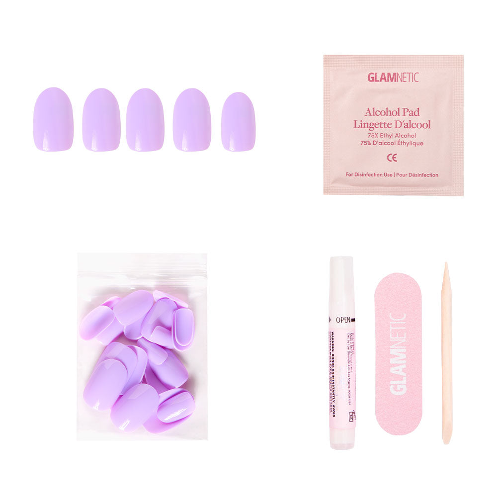 The glamnetic Lilac Nail Set includes purple press-on nails, an alcohol pad, extra nails, nail glue, a pink file, and a cuticle stick—all arranged on a white background.