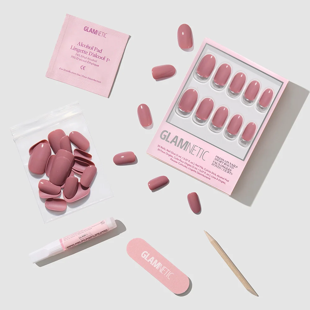 A flat lay of glamnetic's Mauve Mood Press-On Nails kit, featuring salon-quality essentials—nails, extra nails, a nail file, cuticle stick, glue, and an alcohol pad—neatly arranged on a light background.