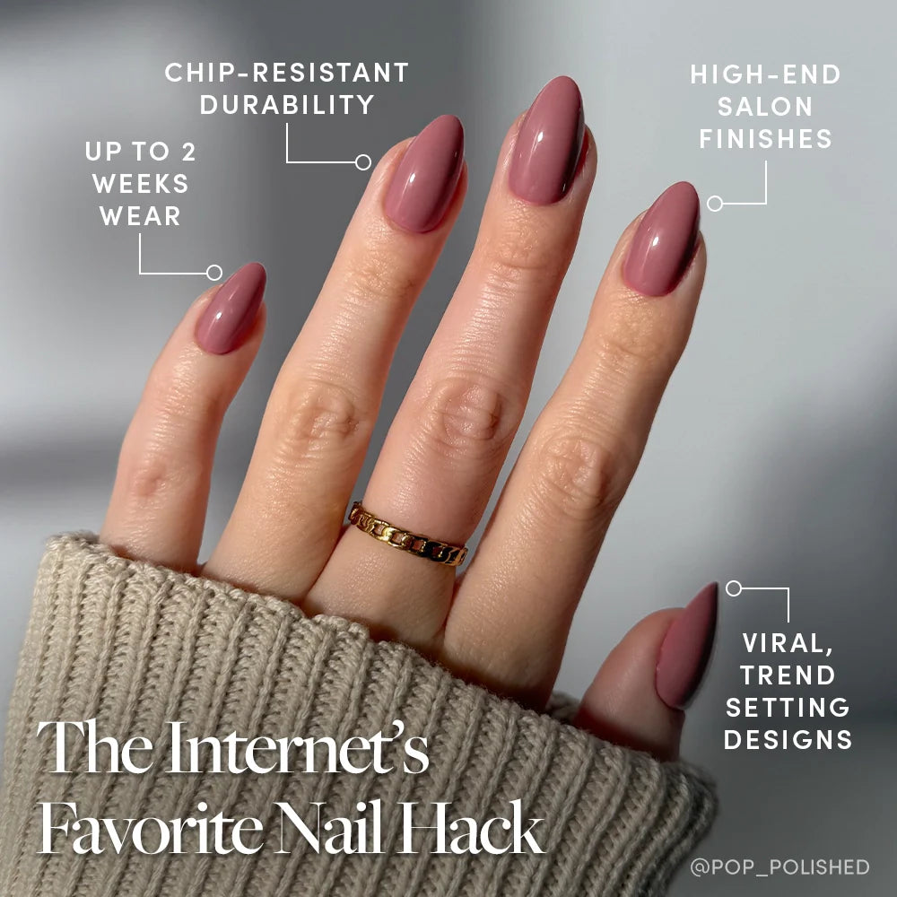 A hand with long, almond-shaped mauve nails wears glamnetic’s Mauve Obsession press-ons, featuring chip-resistant durability, a glossy finish, up to 2 weeks' wear, high-end salon quality, and viral trend-setting designs.