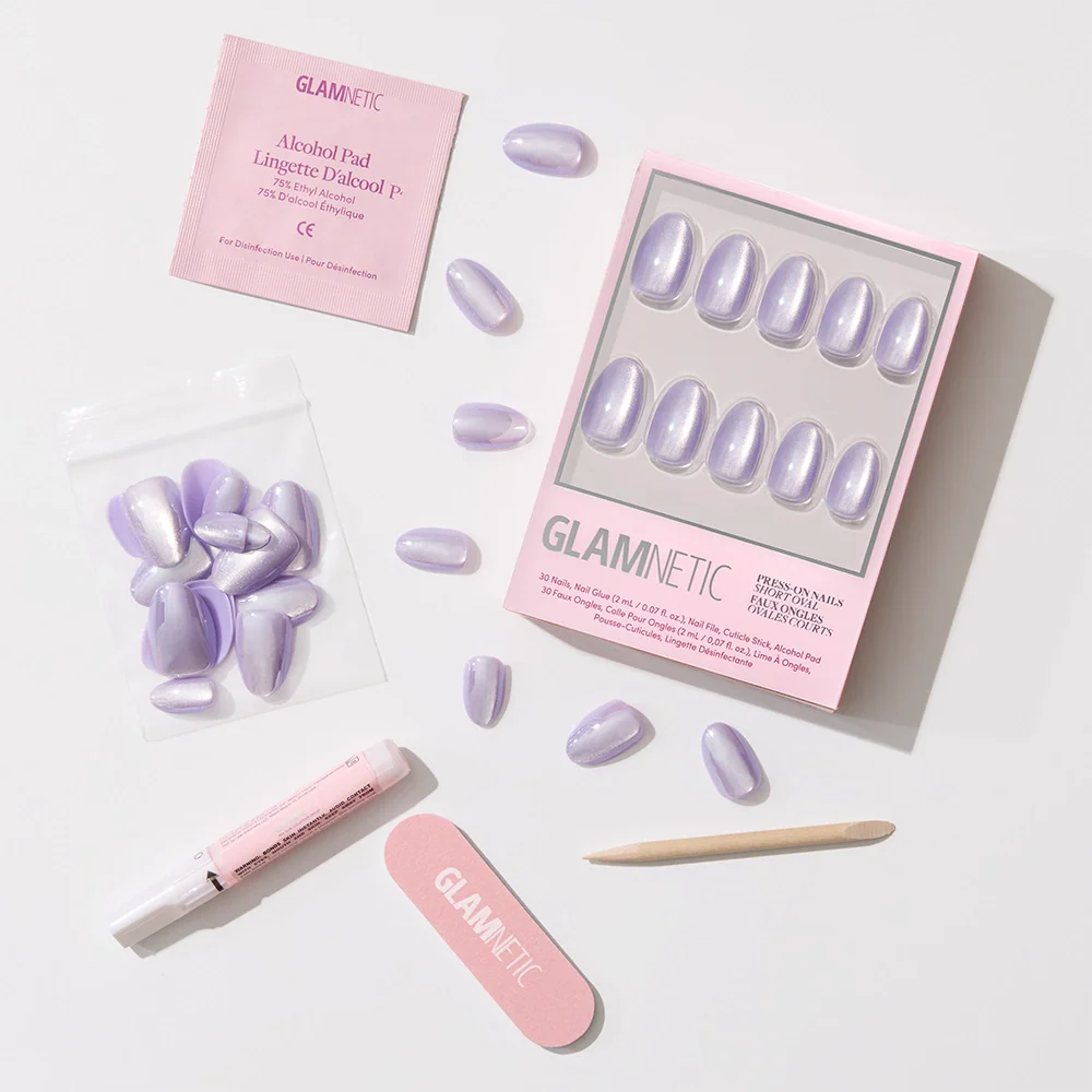 A set of glamnetic Mermaids Tail iridescent purple press-on nails with a glossy finish, shown with an applicator tube, nail file, wooden cuticle stick, alcohol pad, and extra nails on a white background.