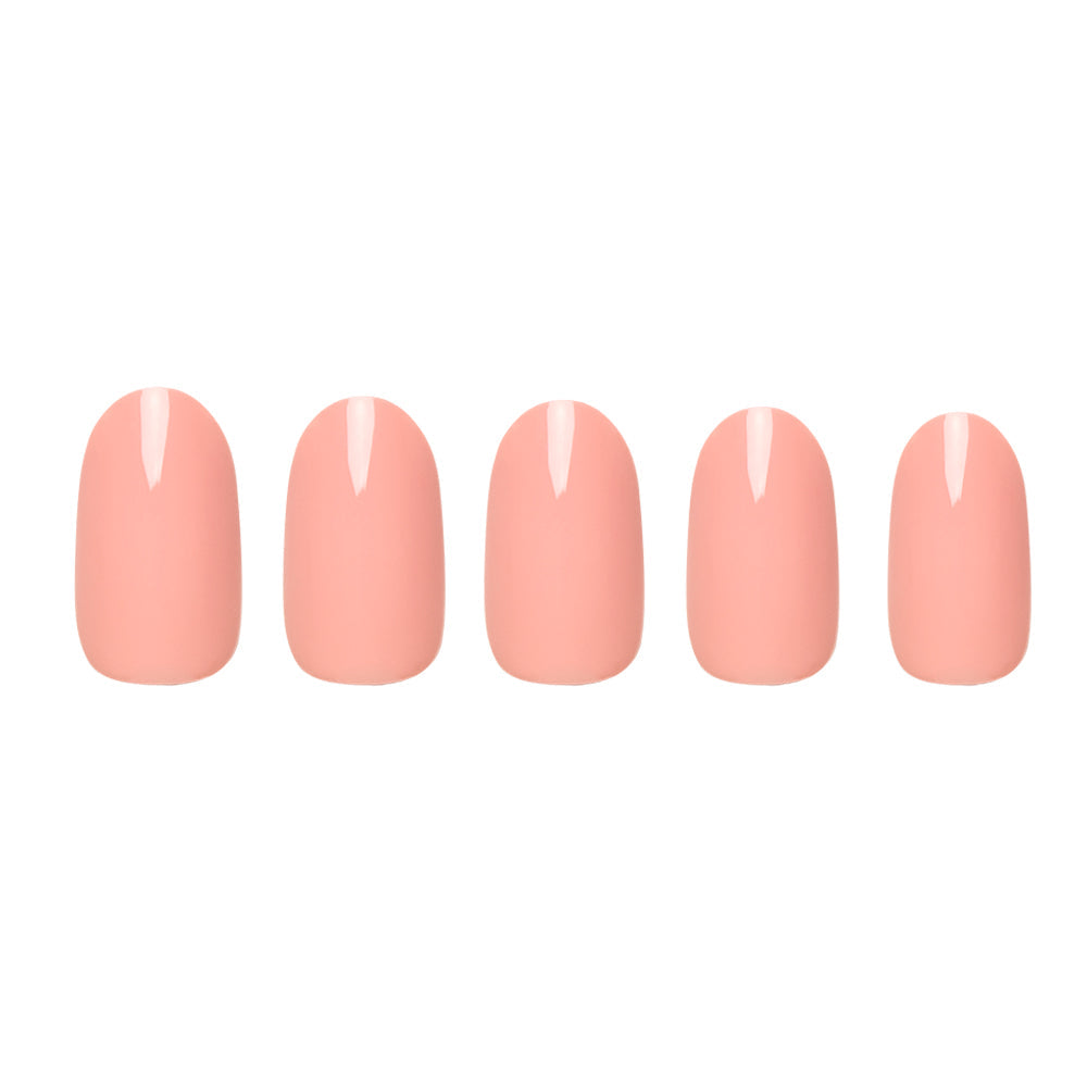 Five glossy, pastel peach artificial nails from glamnetics Peach Coral set are arranged in a row on a white background, highlighting their elegant design.