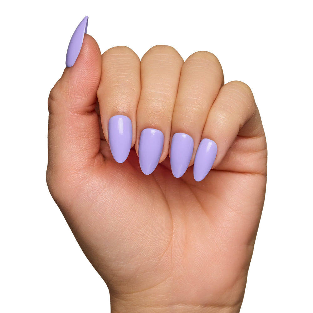 A hand with almond-shaped glamnetic Periwinkle press-on nails in a glossy finish, fingers curled inward, shown against a white background.