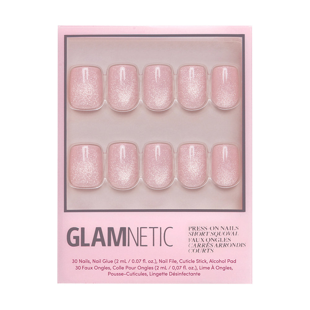 The glamnetic Pinky Promise set includes 30 reusable short squoval nails in blush pink with a glittery velvet finish, plus nail glue, file, cuticle stick, and alcohol pad—all in chic pink packaging.