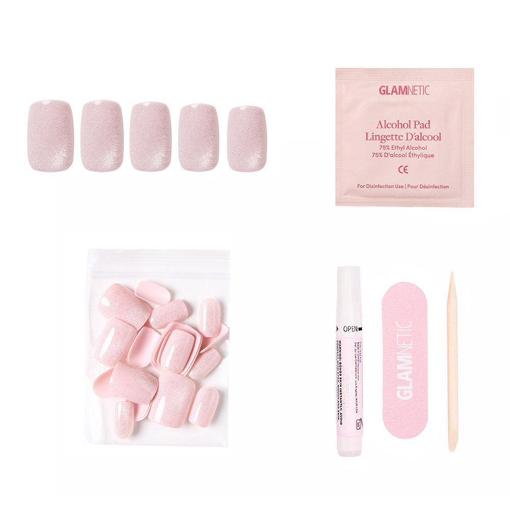 The glamnetic Pinky Promise kit includes short squoval blush velvet press-on nails, reusable and extra nails, glue, a pink file, an alcohol pad, and a cuticle stick—all arranged on a white background.