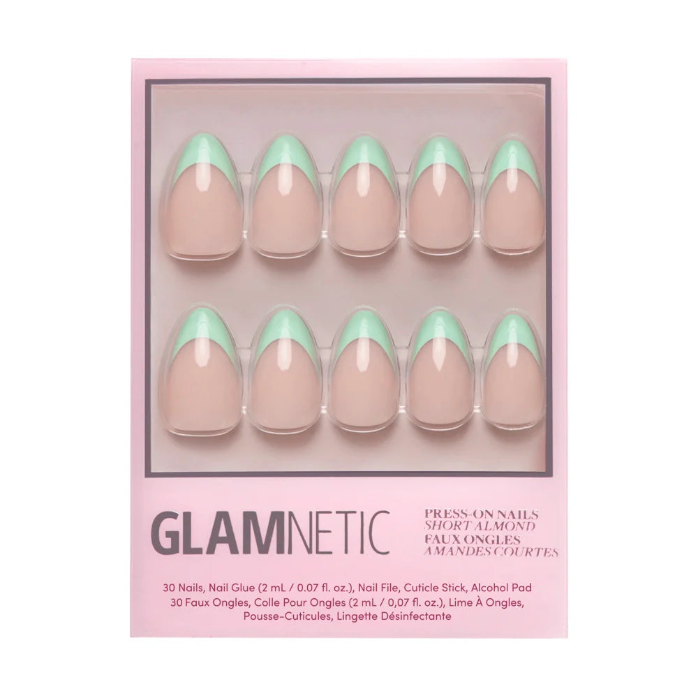 The glamnetic Pistachio Crème Press-On Nail Set includes 10 short almond nails with a nude base and mint green French tips, plus nail glue and manicure accessories in a pink box.