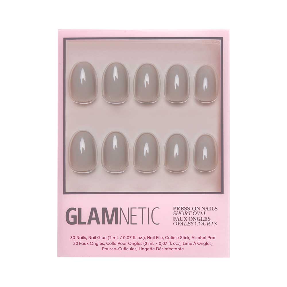 A box of glamnetic Pure Gray press-on nails in a short oval shape features glossy gray nails arranged in two rows inside chic pink packaging.