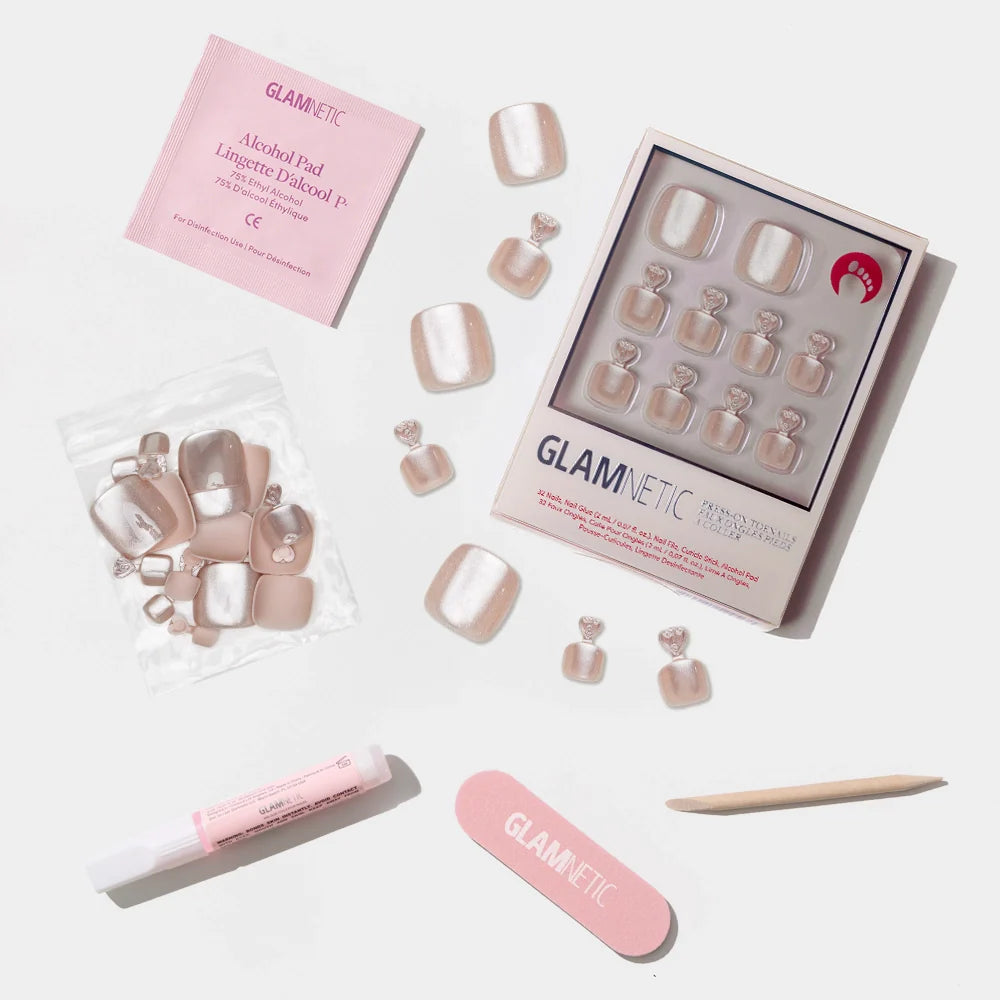 A flat-lay of the Glamnetic shimmer champagne press-on toenail kit with pearly shine and full application set.