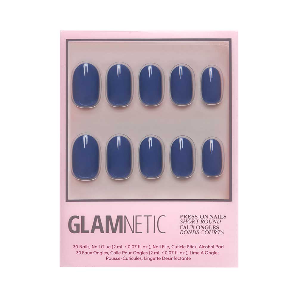 A box of Glamnetic Regal Blue press-on nails in a short, rounded shape with a glossy finish. Comes in pink packaging with nail glue, file, cuticle stick, and alcohol pad. All nails are vegan and cruelty-free.