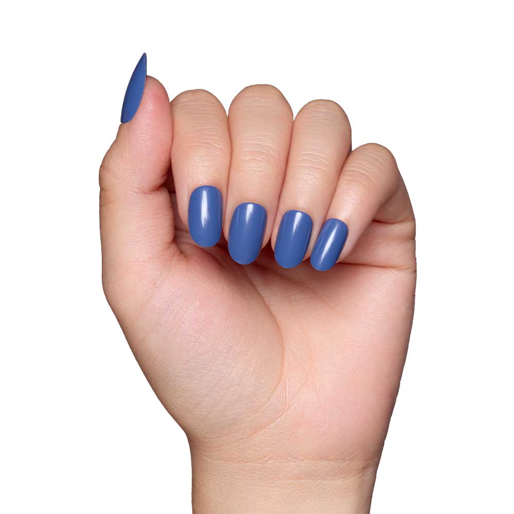A hand with neatly manicured nails painted in Regal Blue nail polish, showcasing a glossy finish, is displayed against a plain white background.