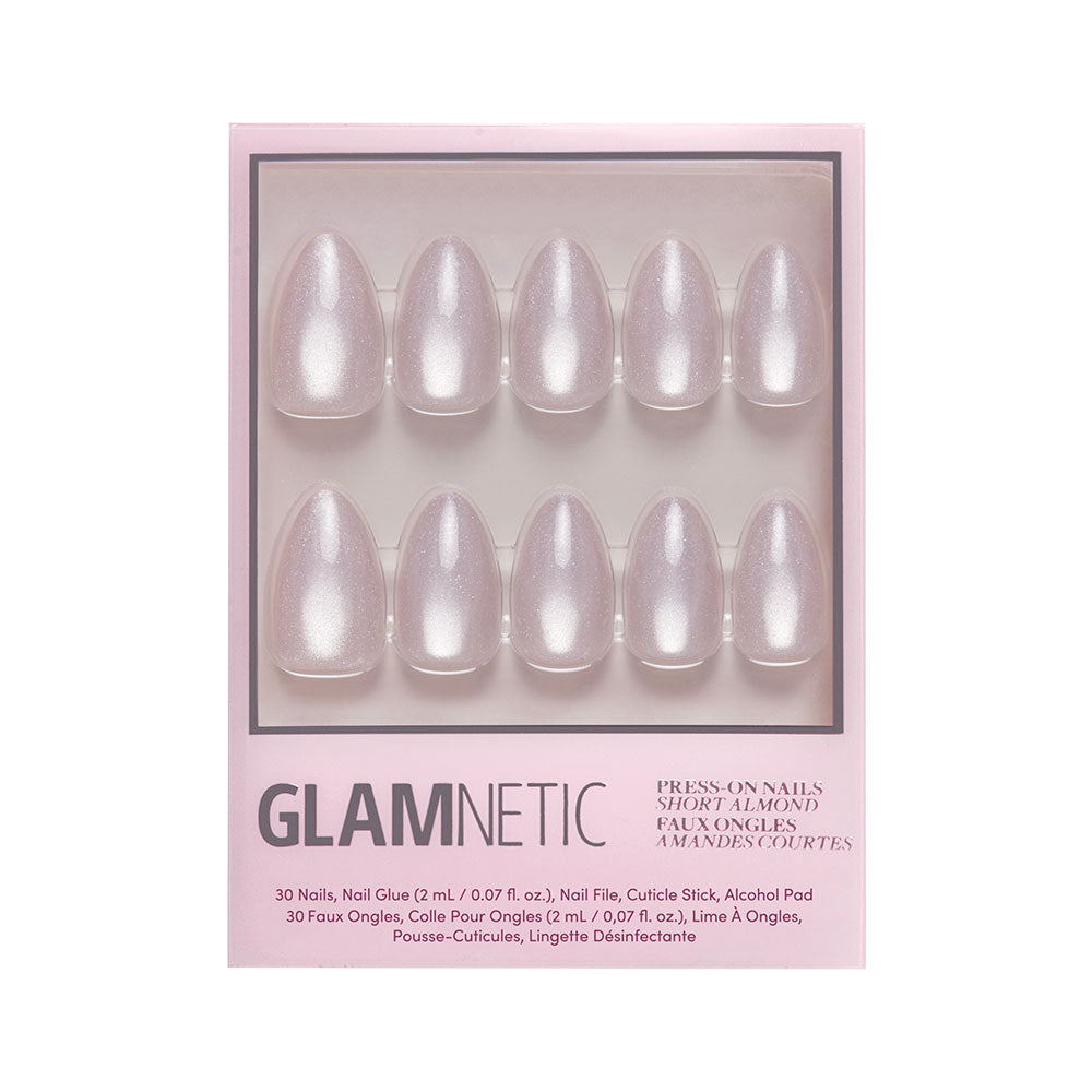A box of glamnetic Selenite short almond press-on nails in pearly light pink with a velvet finish. Includes 10 nails plus nail glue, file, cuticle stick, and alcohol pad.