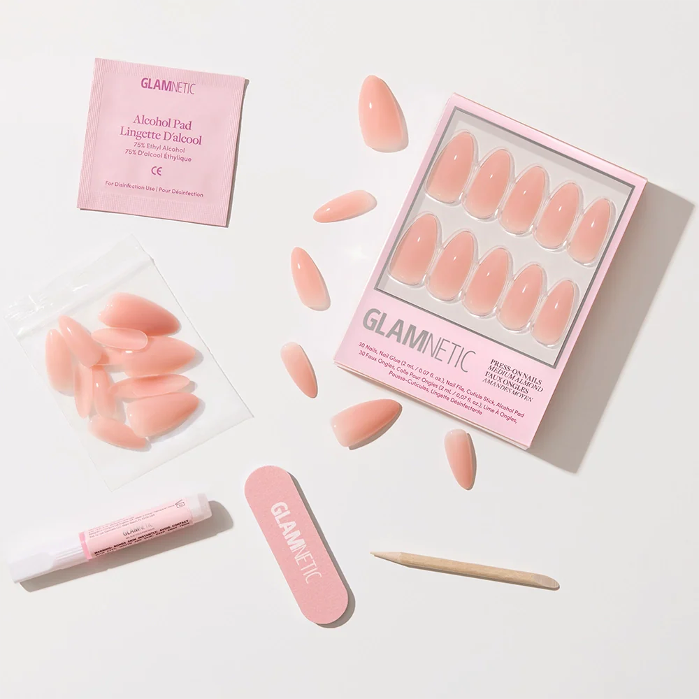 The glamnetic Sheer Pink set includes pink press-on nails, a nail file, wooden cuticle stick, glue, extra nails in a bag, and an alcohol pad—everything you need for a clean-girl look or soft-glam aesthetic.