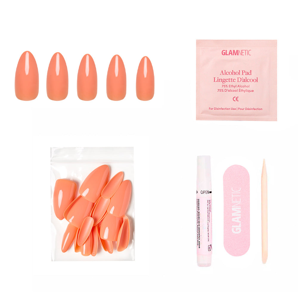 The glamnetic Soft Tangerine Nail Set includes pastel orange press-on nails, an alcohol pad, extra nails, nail glue, a pink nail file, and a wooden cuticle stick for salon-quality acrylics at home.