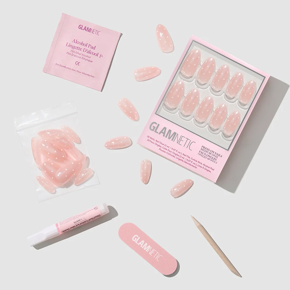 Glamnetic press-on nails with packaging and application tools on a light gray background