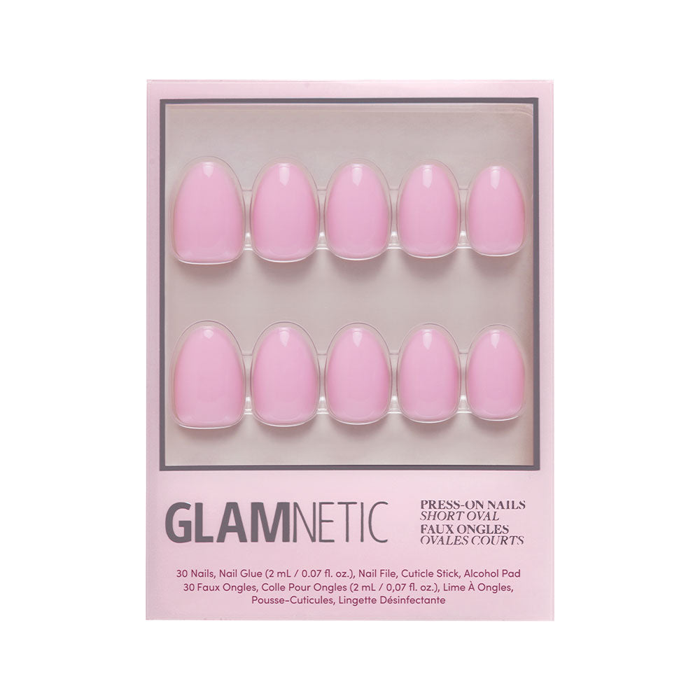 The glamnetic Think Pink set includes 10 short oval press-on nails in a soft baby pink shade, neatly arranged in two rows. Packaging displays items and product info at the bottom.