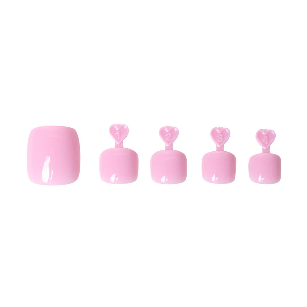 Glossy pastel pink press-on toenails in five sizes, each with heart-shaped tabs for application.