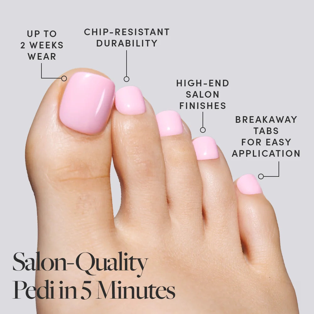 A foot with glossy pastel pink Glamnetic press-on toenails, highlighting fast application and long-lasting wear.