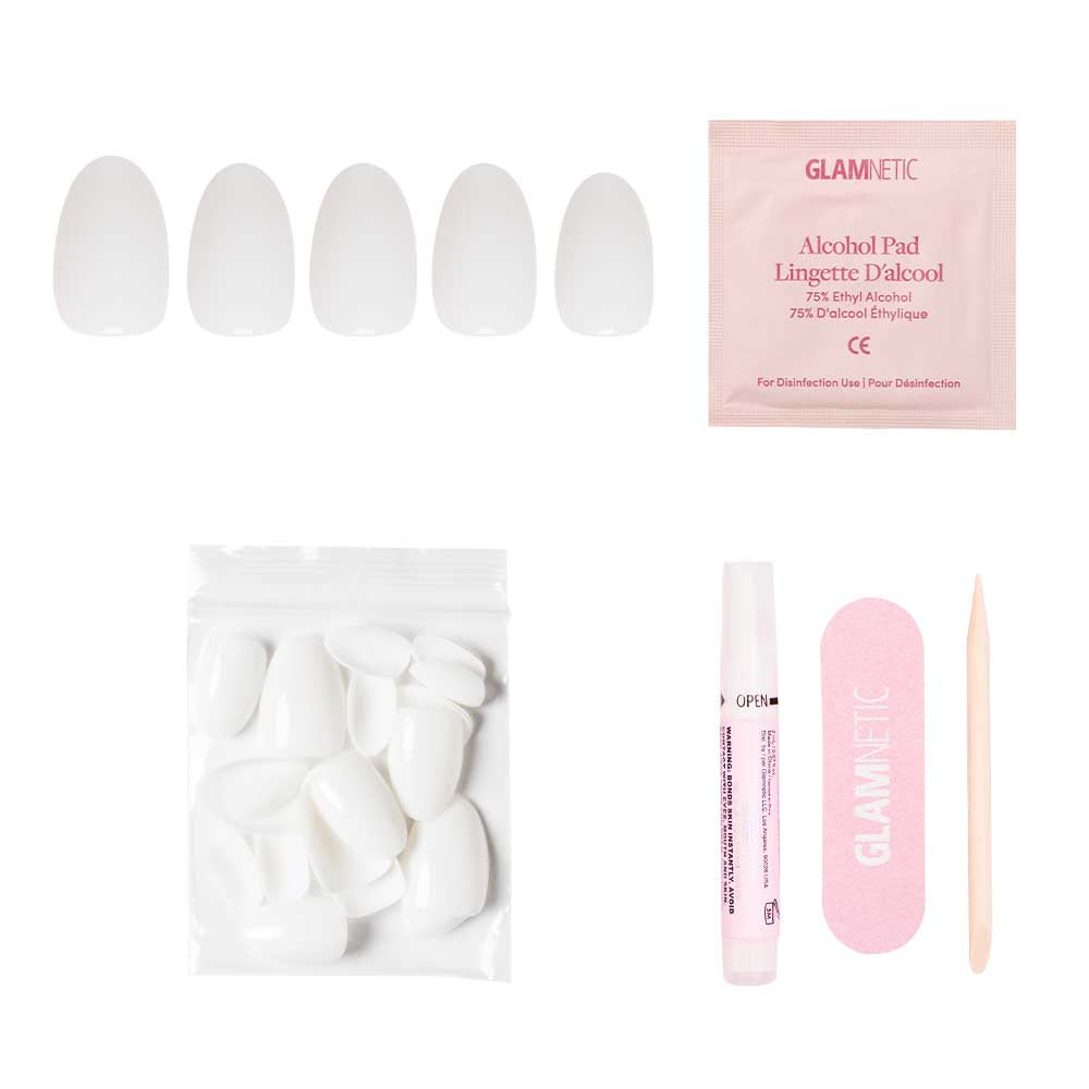 The glamnetic White Swan Nail Set includes short oval press-on nails with a glossy finish, extra nails in a ziplock bag, an alcohol pad, nail glue pen, pink nail file, and wooden cuticle stick—all on a white background.