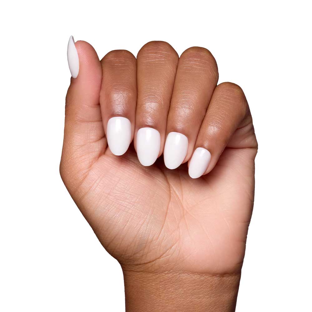 A hand with medium brown skin displays glamnetic’s White Swan nails, featuring a glossy finish and a rounded almond shape, set against a plain white background.