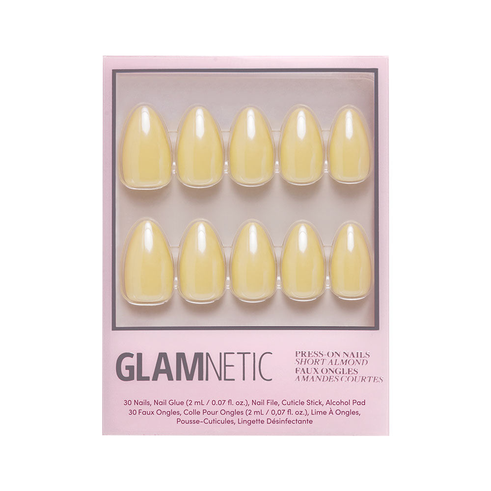 A box of glamnetic Yellow Pop press-on nails in a short almond shape with a pastel yellow color, featuring 10 displayed nails and product info on the packaging.