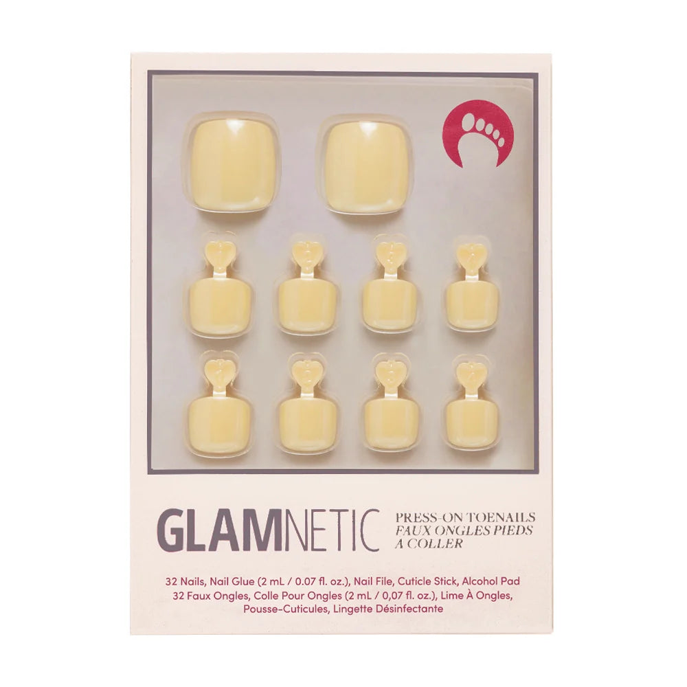 A box of Glamnetic press-on toenails in a creamy pastel yellow color.