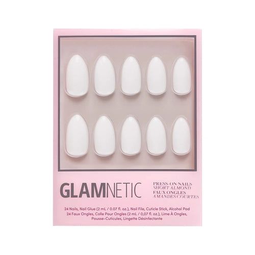 A box of glamnetic Angel vegan press-on nails in a short almond shape. The pink box displays ten white artificial nails through a clear window, with product details printed below.