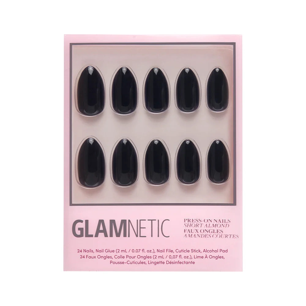 A box of glamnetic Boba black press-on nails in a short almond shape, featuring ten glossy, vegan, cruelty-free nails arranged neatly in two rows on a pink background.